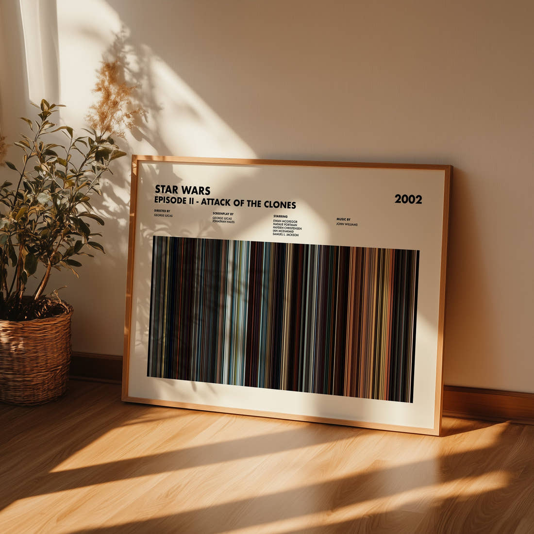 Star Wars: Episode II Attack of the Clones Movie Barcode Poster framed and leaning against a wall on a wooden floor