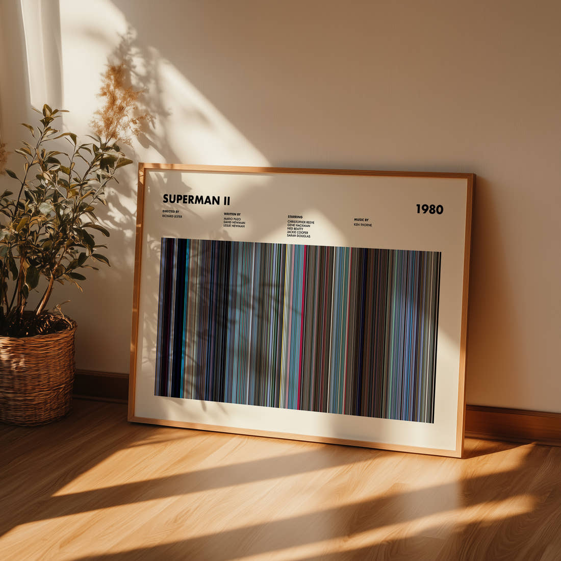 Superman 2 Movie Barcode Poster framed and leaning against a wall on a wooden floor