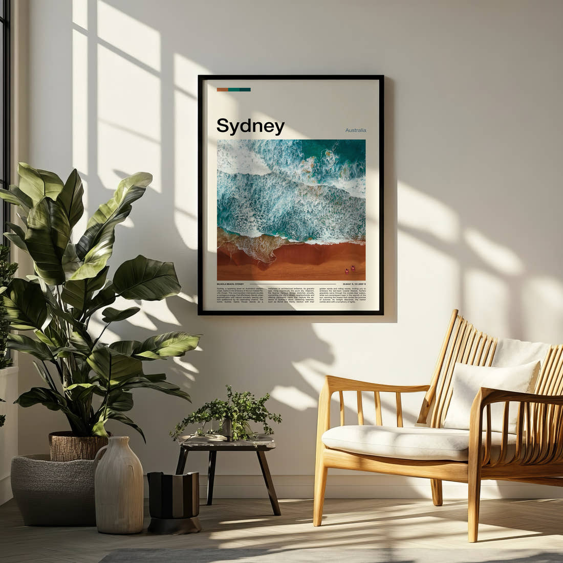 Sydney Aerial Waves On Sand Travel Print framed on a pale wall beside houseplants