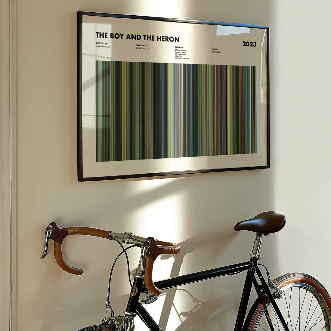 The Boy and the Heron Movie Barcode Poster framed on the wall of a styled room setting