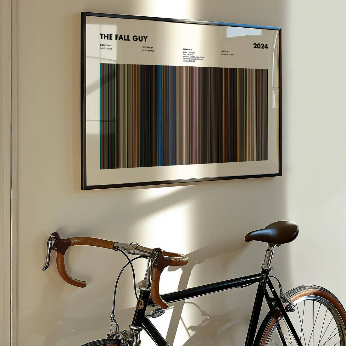 The Fall Guy Movie Barcode Poster framed on the wall of a styled room setting