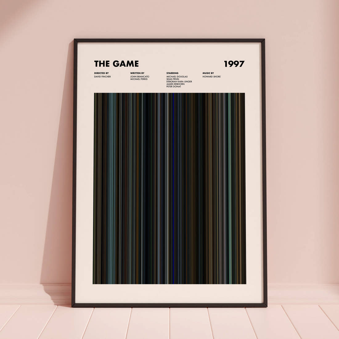 The Game Movie Barcode Poster framed and leaning against a coloured wall