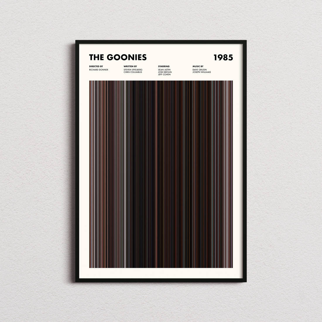 The Goonies Movie Barcode Poster framed on a plain studio wall