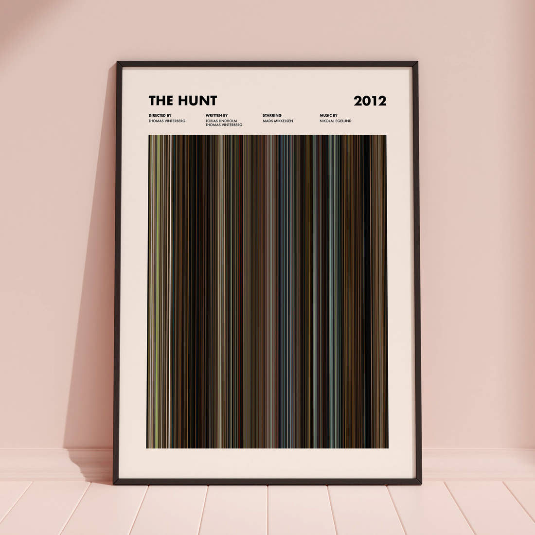 The Hunt 2012 Movie Barcode Poster framed and leaning against a coloured wall