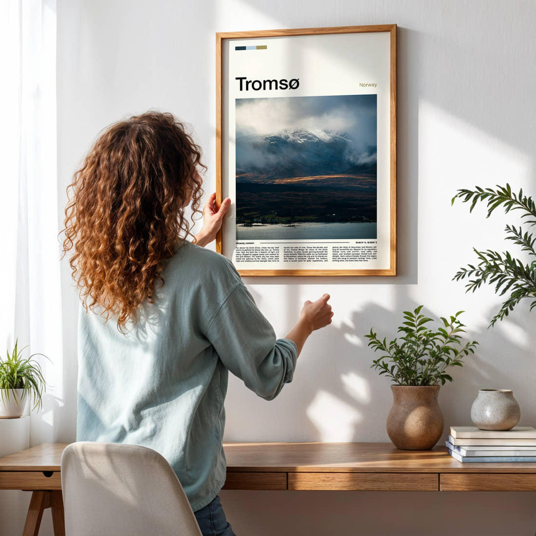 Tromsø Cloud-Wrapped Peak Travel Print framed on a pale wall beside houseplants