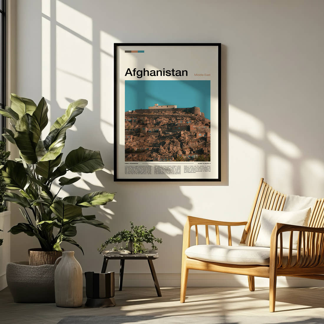 Afghanistan Houses On The Hillside Travel Print framed on a pale wall beside houseplants