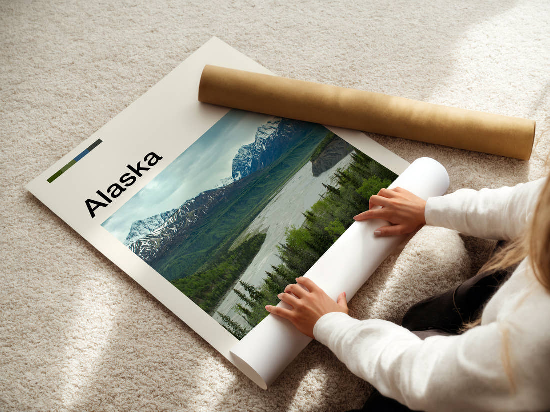 Alaska River Valley And Mountains Travel Print being unrolled from its postal tube