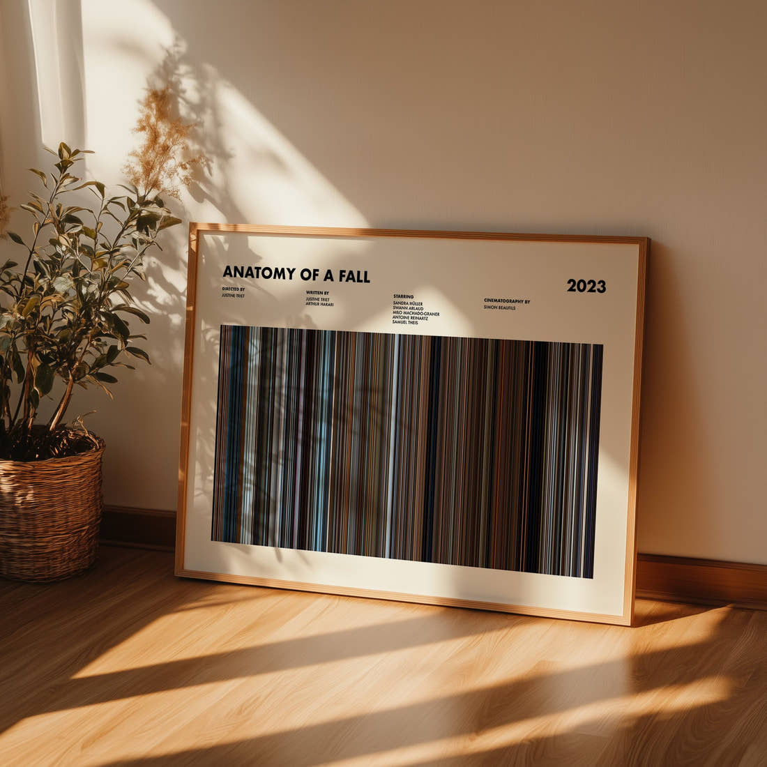 Anatomy of a Fall Movie Barcode Poster framed and leaning against a wall on a wooden floor