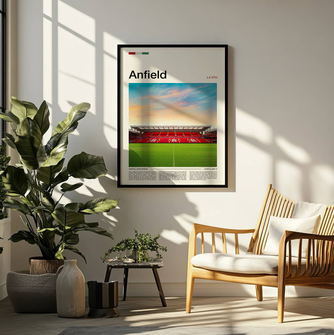 Anfield Stadium Print framed on a pale wall beside houseplants
