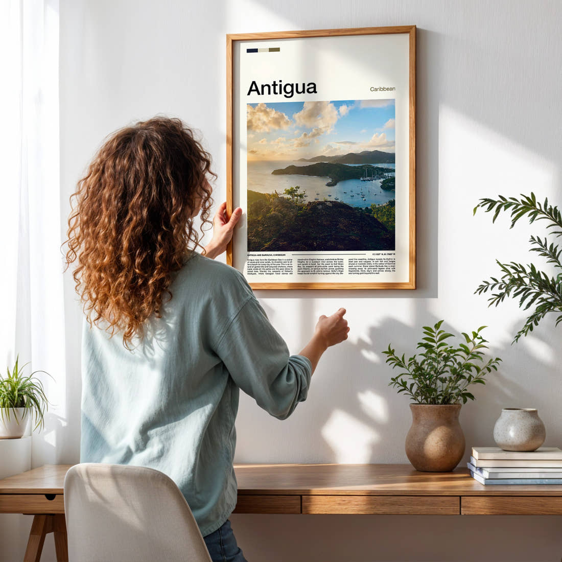 Antigua Harbour From Above Travel Print framed on a pale wall beside houseplants