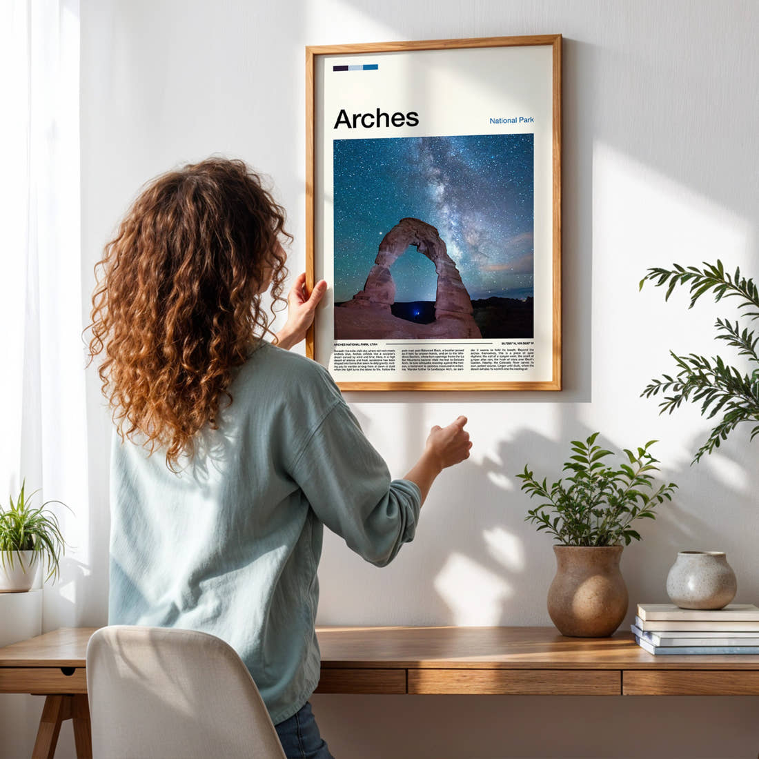 Arches Starlit Sandstone Arch Travel Print framed on a pale wall beside houseplants