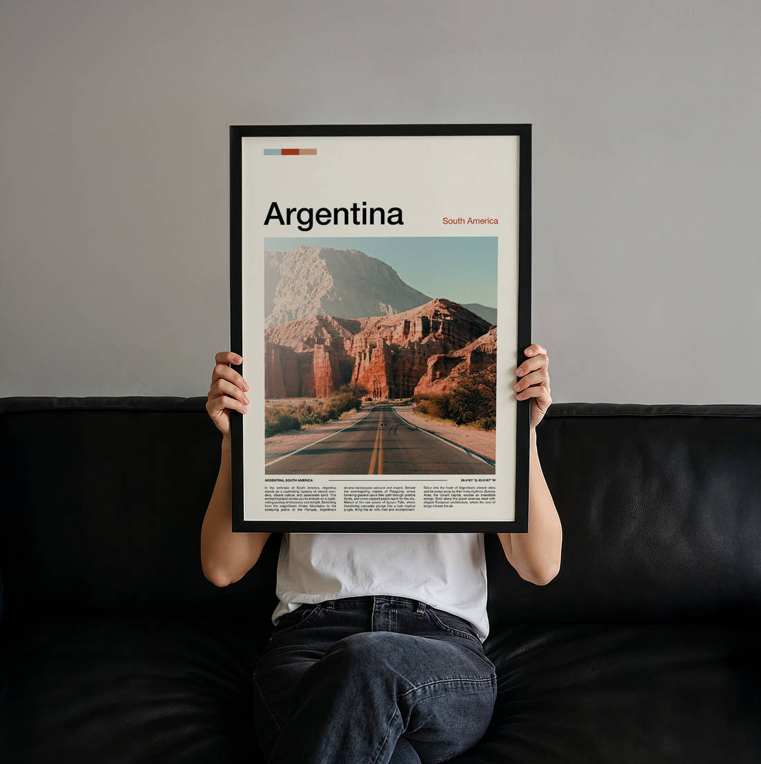 Argentina Road Through Red Rocks Travel Print held up by hand to show the size of the print