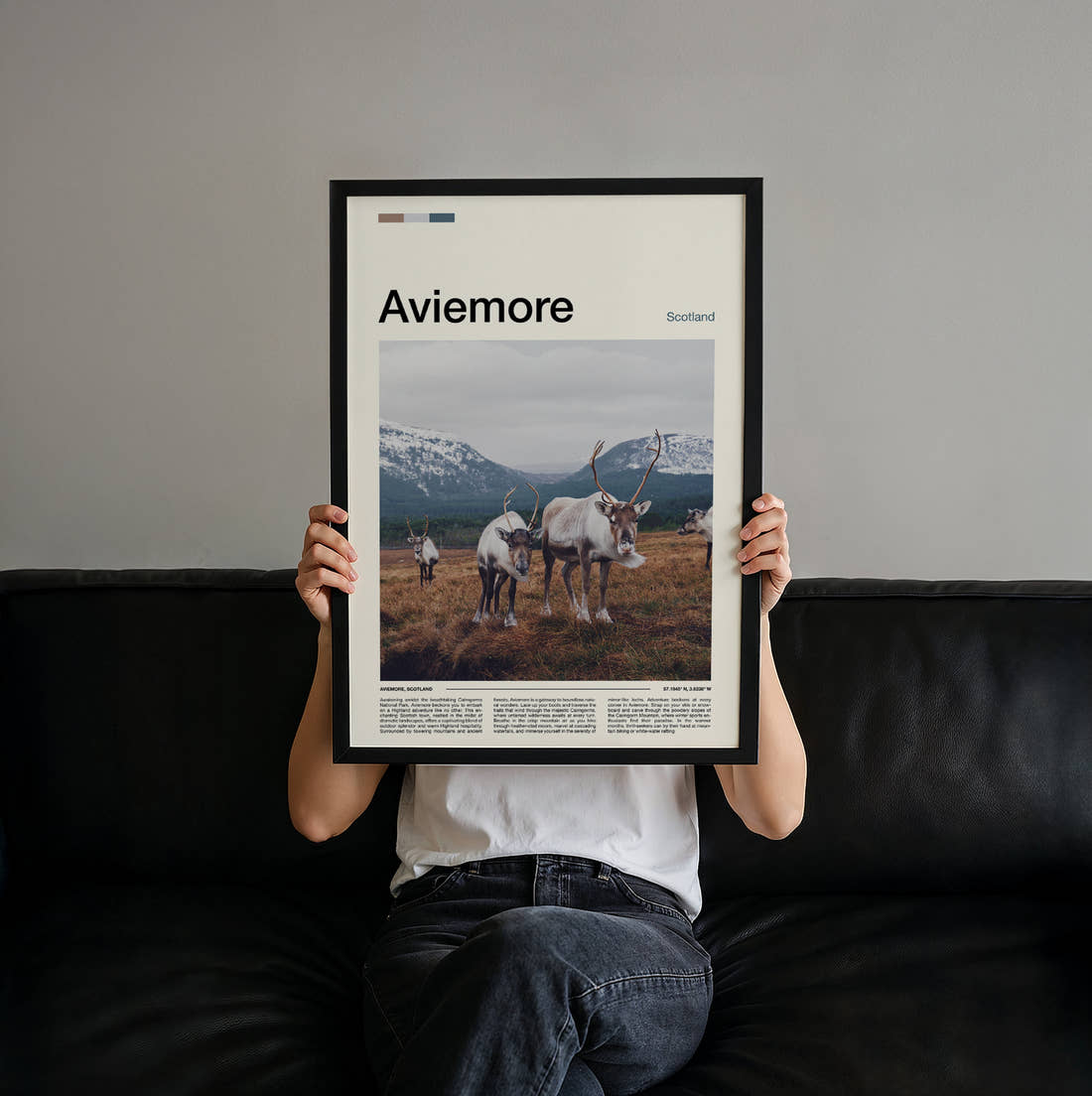 Aviemore Reindeer Travel Print held up by hand to show the size of the print