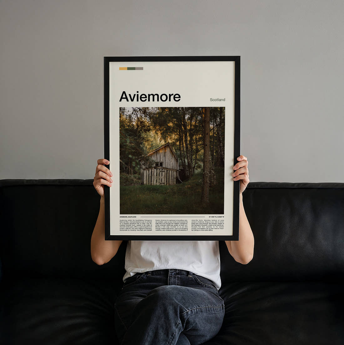 Aviemore Wooden Hut In Forest Travel Print held up by hand to show the size of the print