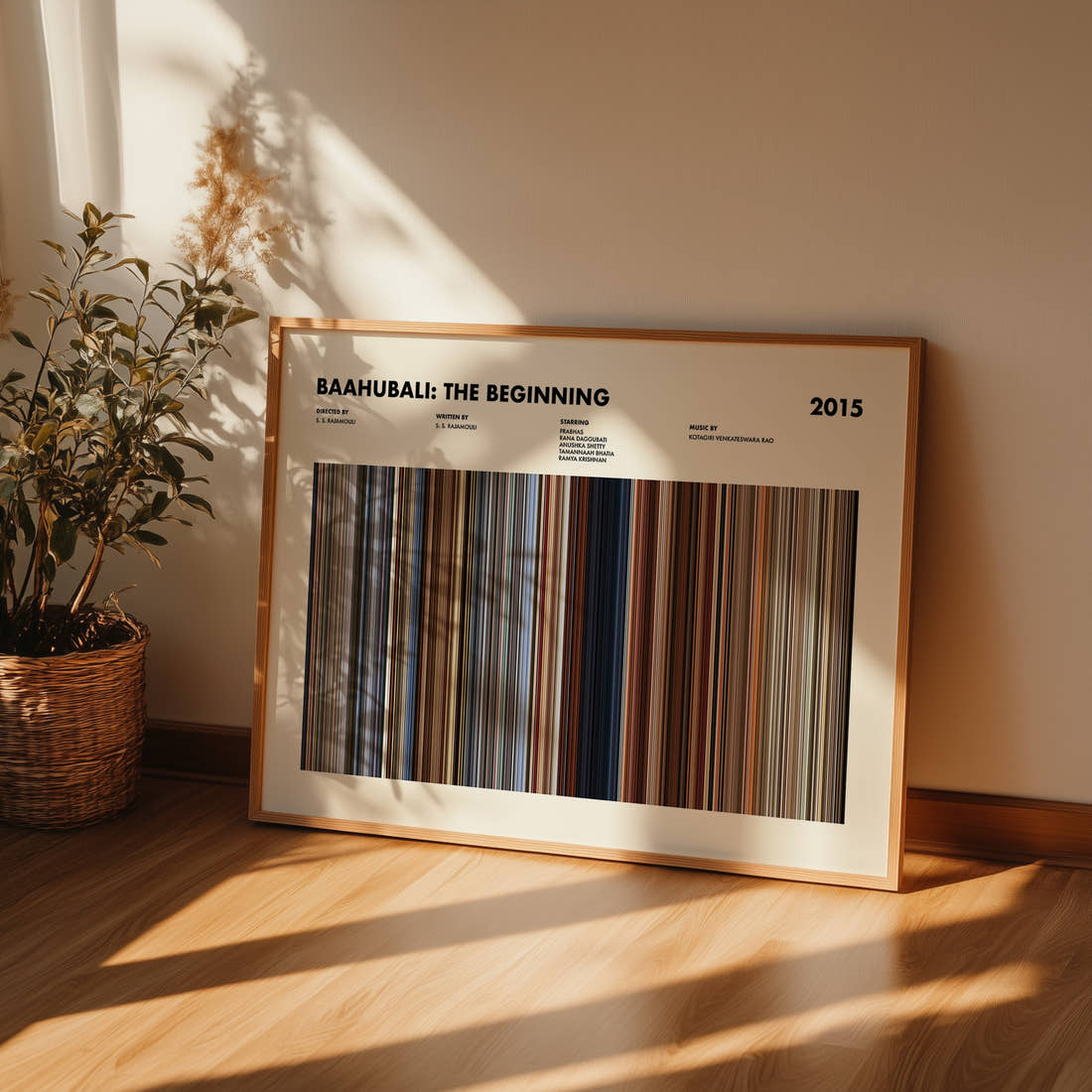 Baahubali: The Beginning Movie Barcode Poster framed and leaning against a wall on a wooden floor