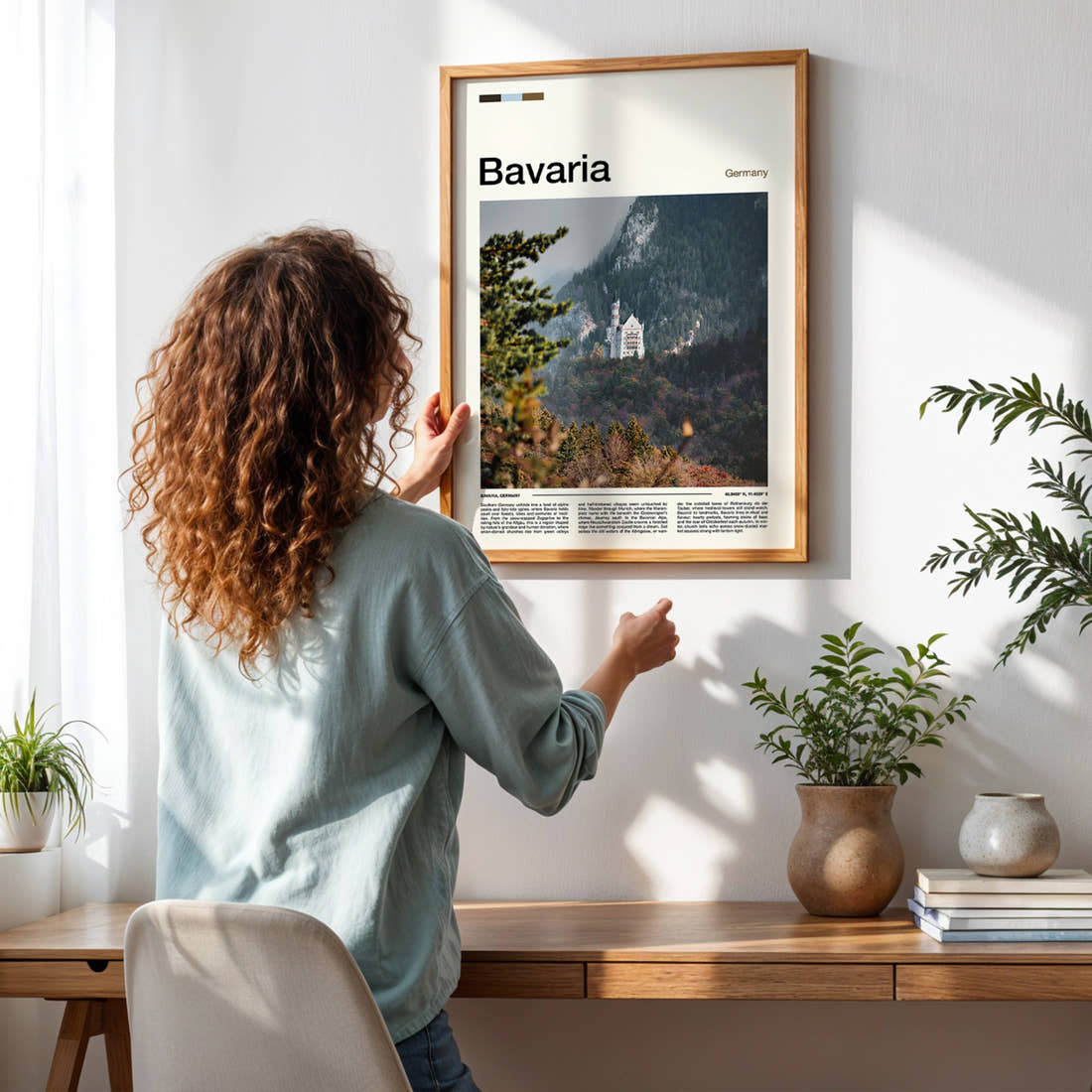Bavaria Fairy-Tale Castle Valley Travel Print framed on a pale wall beside houseplants