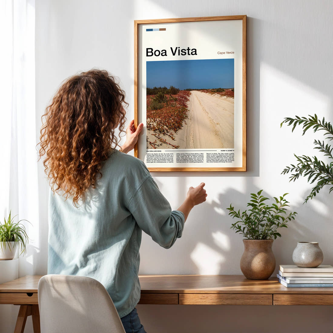 Boa Vista Sandy Desert Track Travel Print framed on a pale wall beside houseplants
