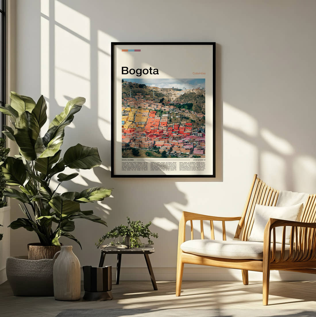 Bogota Colourful Hillside Houses Travel Print framed on a pale wall beside houseplants