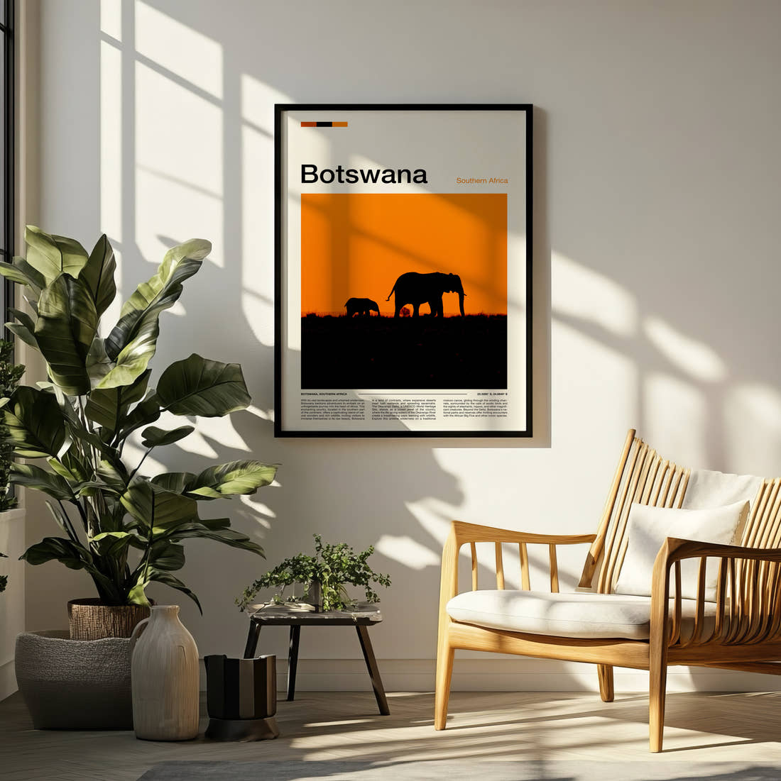 Botswana Elephants At Sunset Travel Print framed on a pale wall beside houseplants