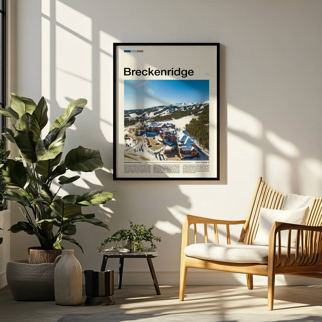 Breckenridge Snowy Resort Village Travel Print framed on a pale wall beside houseplants