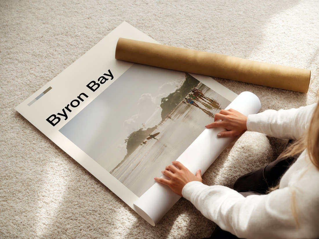 Byron Bay Surfers On The Beach Travel Print being unrolled from its postal tube