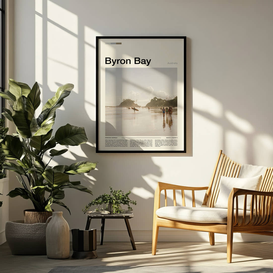 Byron Bay Surfers On The Beach Travel Print framed on a pale wall beside houseplants