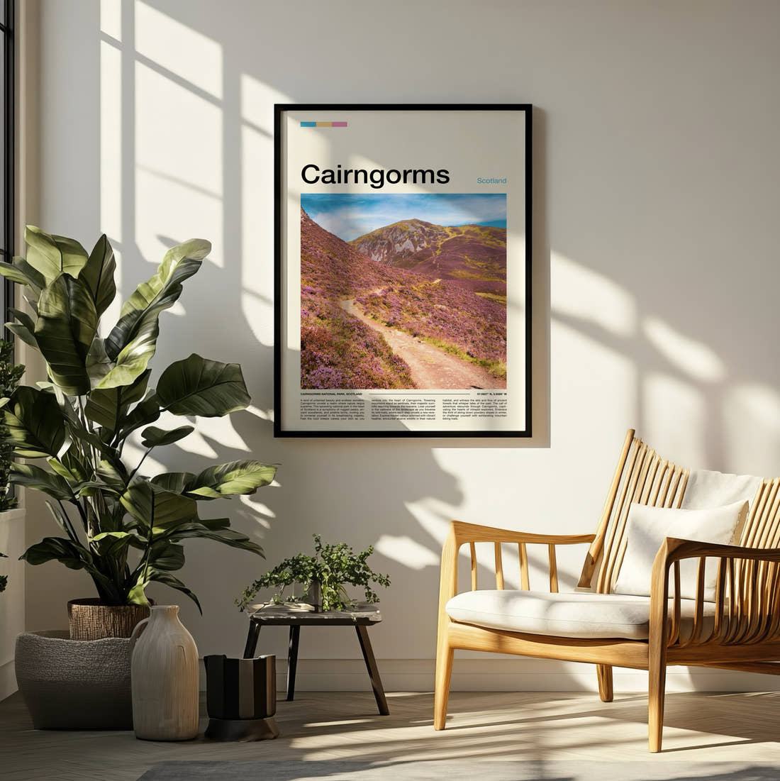 Cairngorms Purple Heather Hillside Travel Print framed on a pale wall beside houseplants