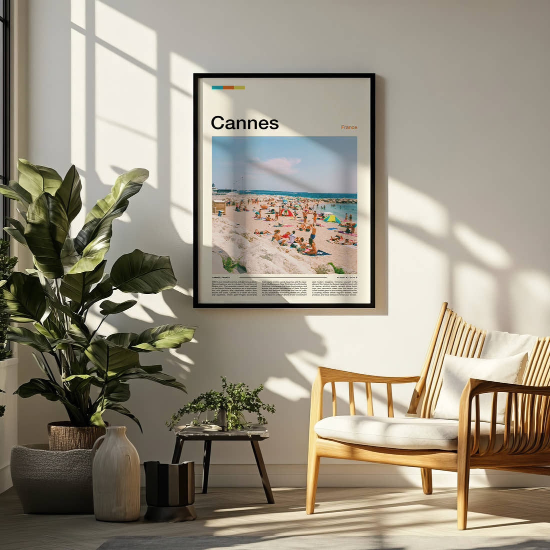 Cannes Crowded Beach Travel Print framed on a pale wall beside houseplants