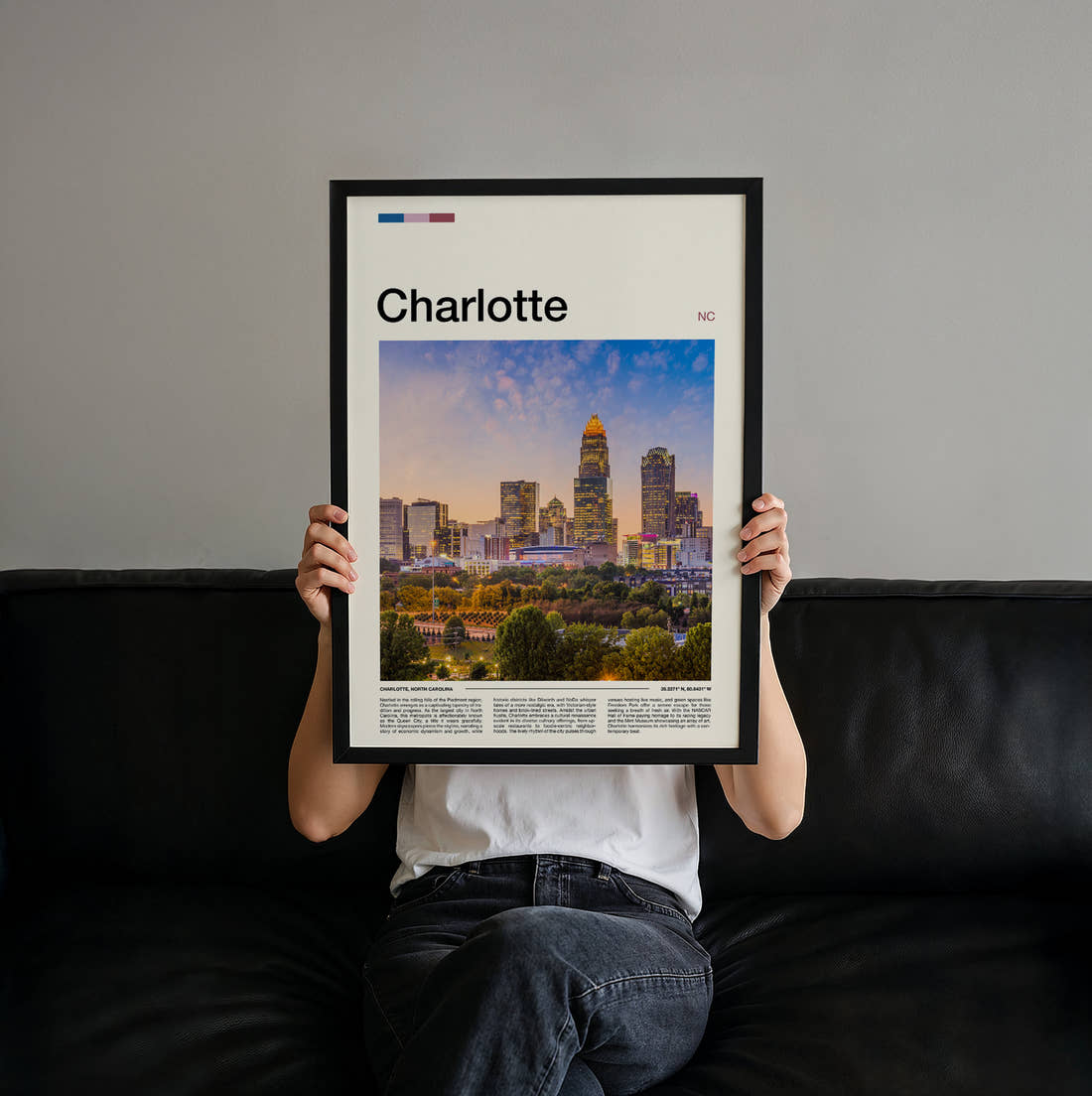 Charlotte Skyline At Dusk Travel Print held up by hand to show the size of the print