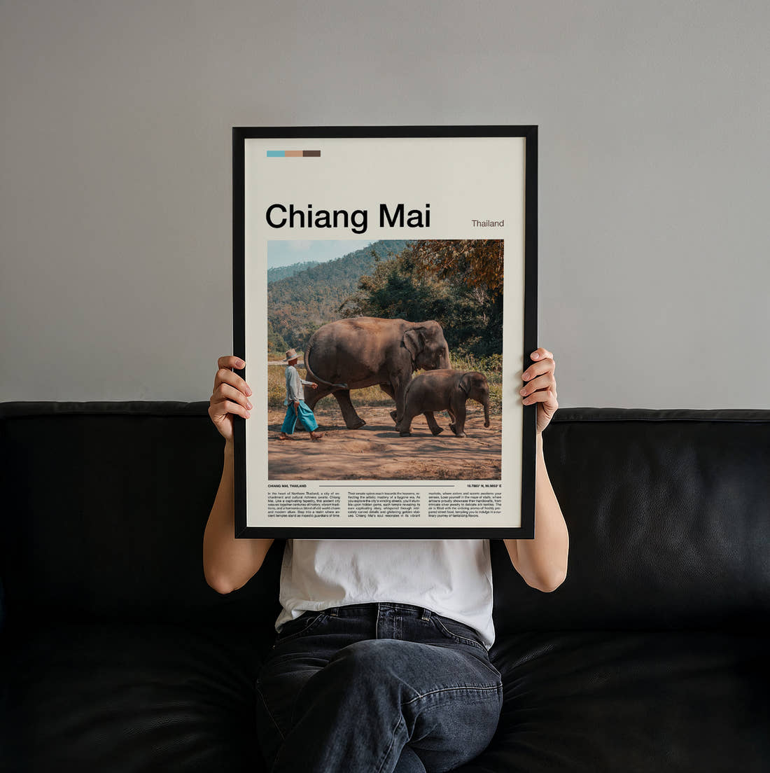 Chiang Mai Elephants Travel Print held up by hand to show the size of the print