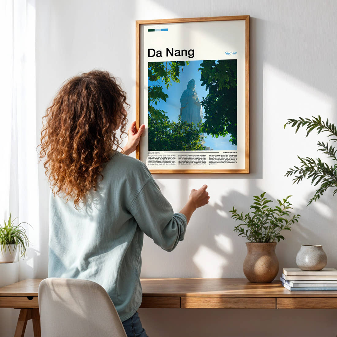 Da Nang Lady Buddha Statue Travel Print framed on a pale wall beside houseplants