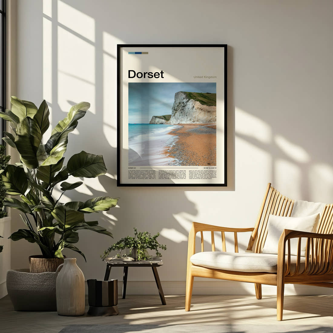 Dorset Chalk Cliffs And Beach Travel Print framed on a pale wall beside houseplants