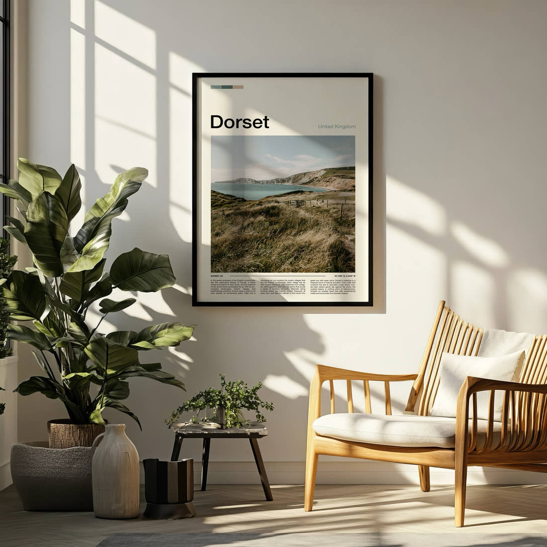 Dorset Clifftop Over The Bay Travel Print framed on a pale wall beside houseplants