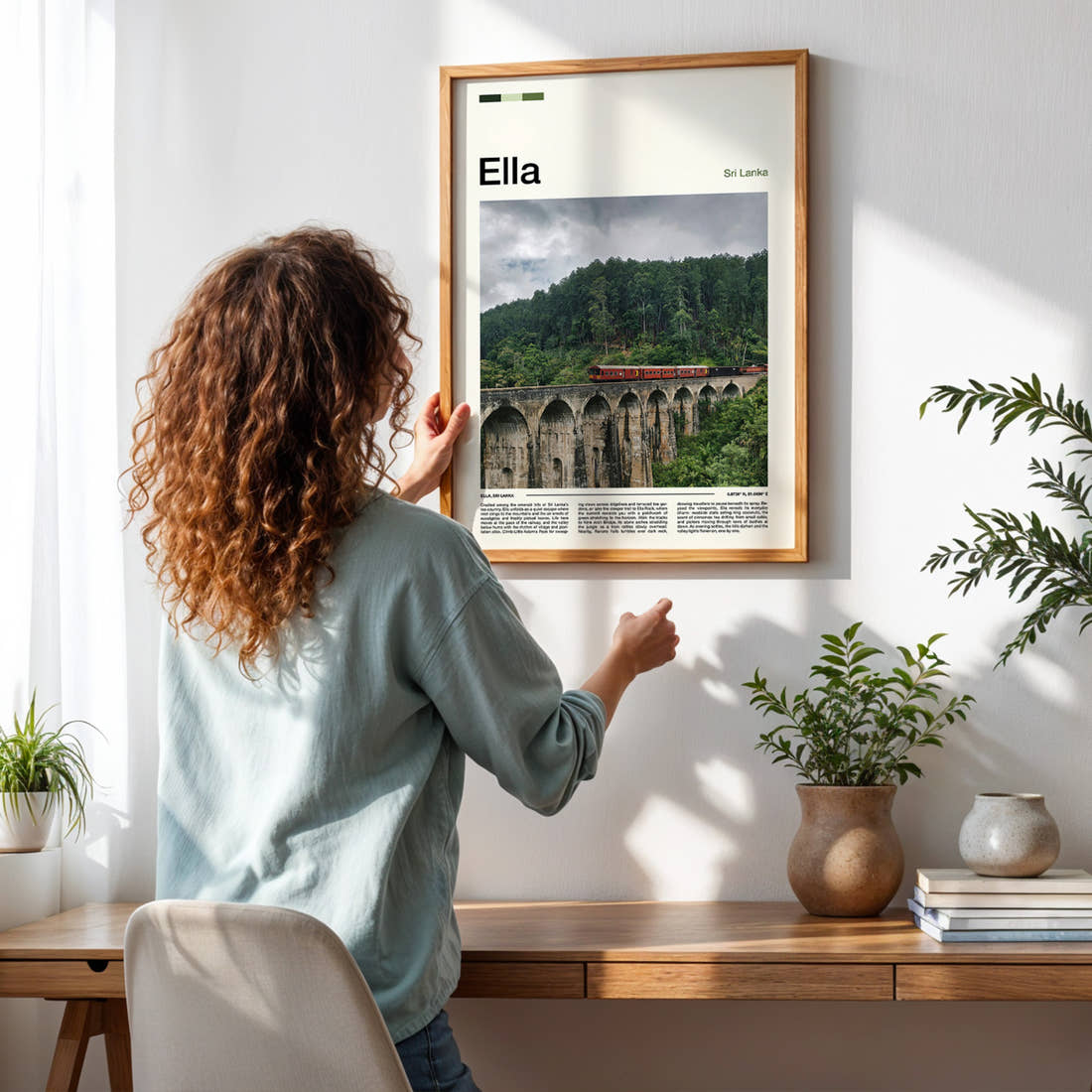 Ella Nine Arch Bridge Travel Print framed on a pale wall beside houseplants