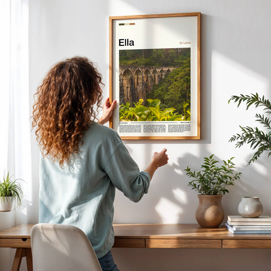 Ella Nine Arch Bridge Travel Print framed on a pale wall beside houseplants