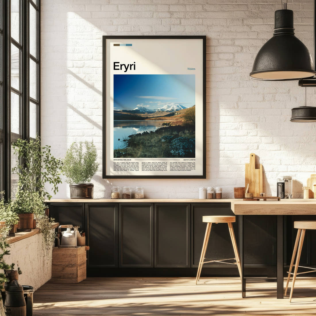 Eryri Snow-Capped Mountain Range Travel Print framed on the wall of a bright kitchen and dining space