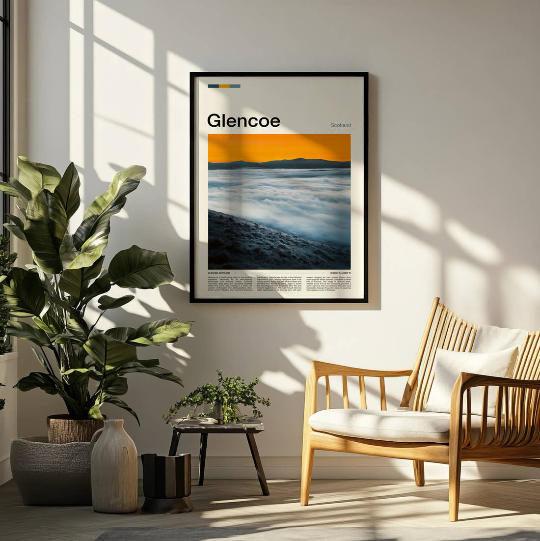Glencoe Above The Clouds Travel Print framed on a pale wall beside houseplants