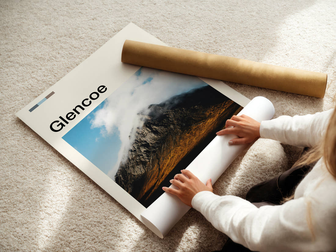 Glencoe Cloud Capped Mountain Travel Print being unrolled from its postal tube