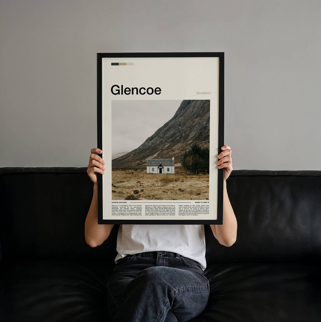 Glencoe Lone White Cottage Travel Print held up by hand to show the size of the print