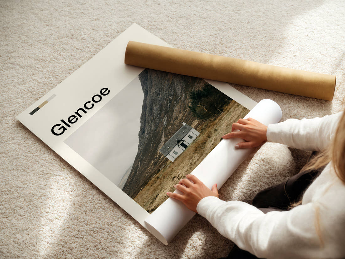 Glencoe Lone White Cottage Travel Print being unrolled from its postal tube