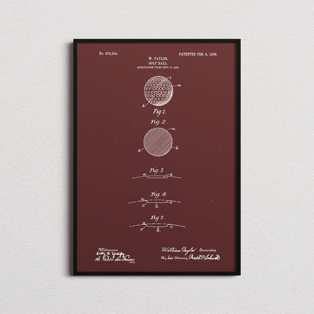 Golf Ball Patent Print in the burgundy colourway, framed