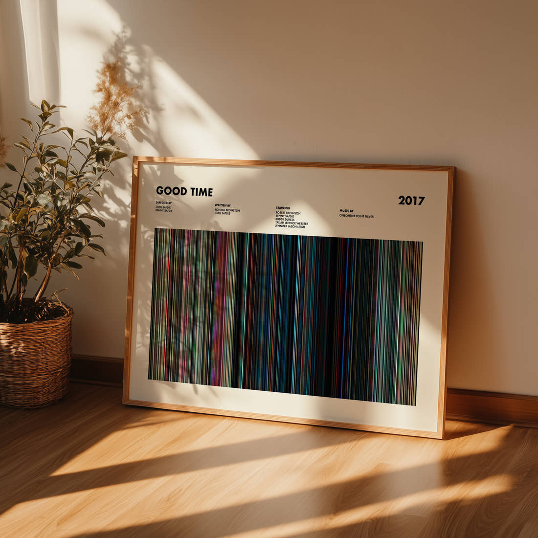 Good Time Movie Barcode Poster framed and leaning against a wall on a wooden floor