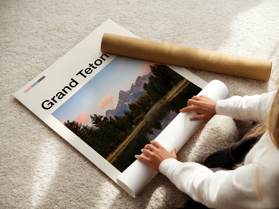 Grand Teton Pines Reflected In The Lake Travel Print being unrolled from its postal tube