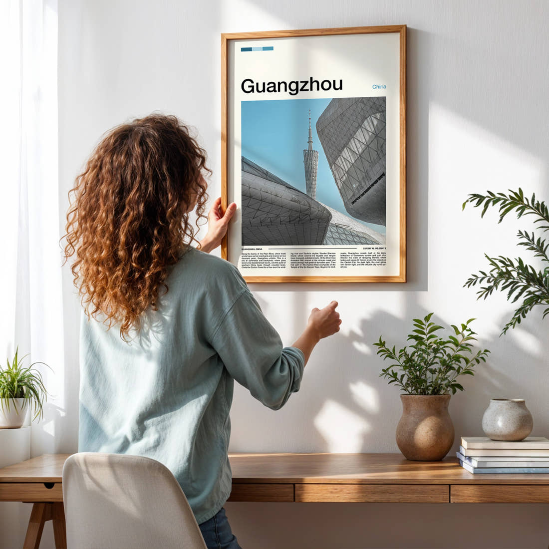 Guangzhou Canton Tower Skyline Travel Print framed on a pale wall beside houseplants