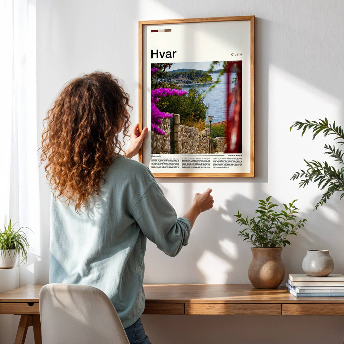 Hvar Coastal Garden View Travel Print framed on a pale wall beside houseplants