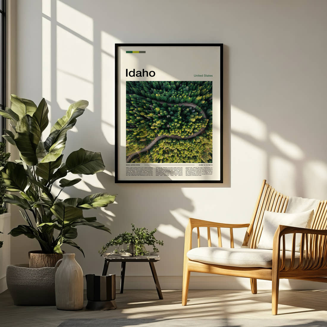 Idaho Winding Road Through Forest Travel Print framed on a pale wall beside houseplants