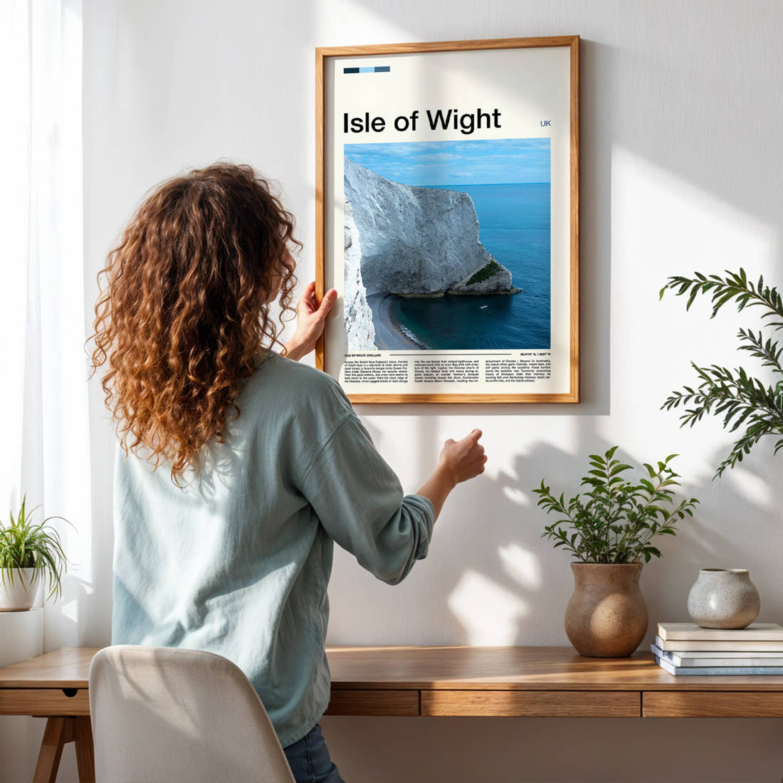 Isle of Wight Chalk Cliff Coastline Travel Print framed on a pale wall beside houseplants