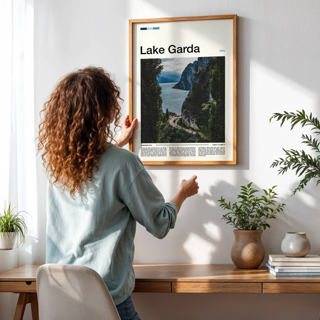 Lake Garda Cliffside Lake Path Travel Print framed on a pale wall beside houseplants