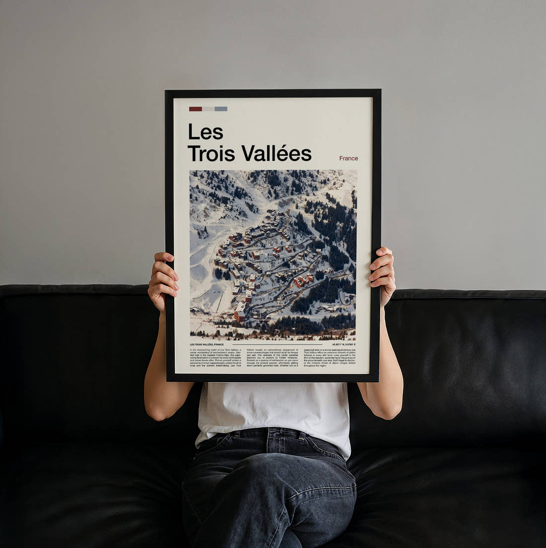 Les Trois Vallees Snowy Ski Village Travel Print held up by hand to show the size of the print