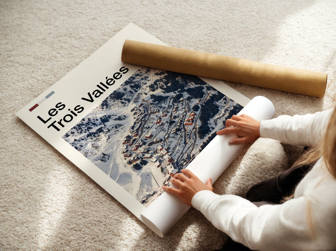 Les Trois Vallees Snowy Ski Village Travel Print being unrolled from its postal tube